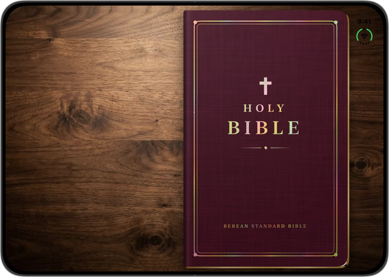 The open iPhone Duo Bible cover on a walnut desk
